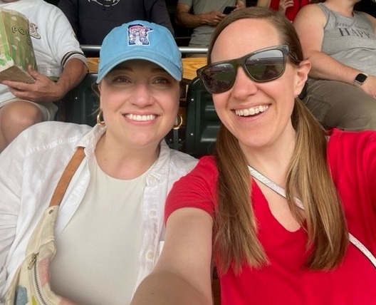 Photograph of Emily and Abbey from the Perspective 6 Client Service team smiling at the Minnesota Twins game.