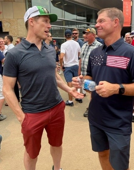 Picture of Matt Nelson and Matt Finley talking shop at a team outing to the Minnesota twins game.