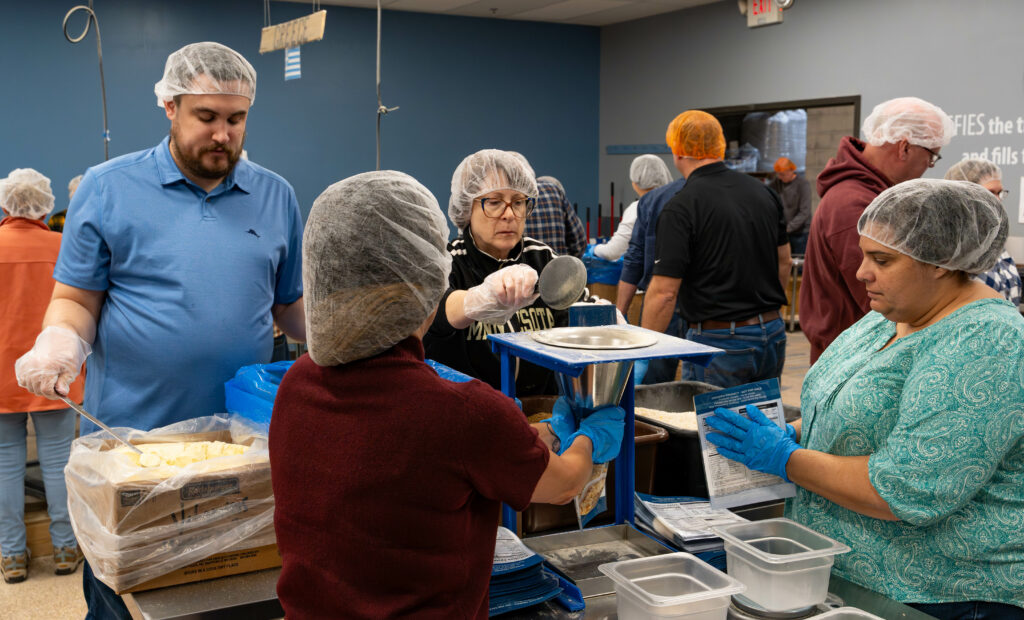 Focus Financial employees and clients packing meals for Feed My Starving Children in Coon Rapids, MN.
