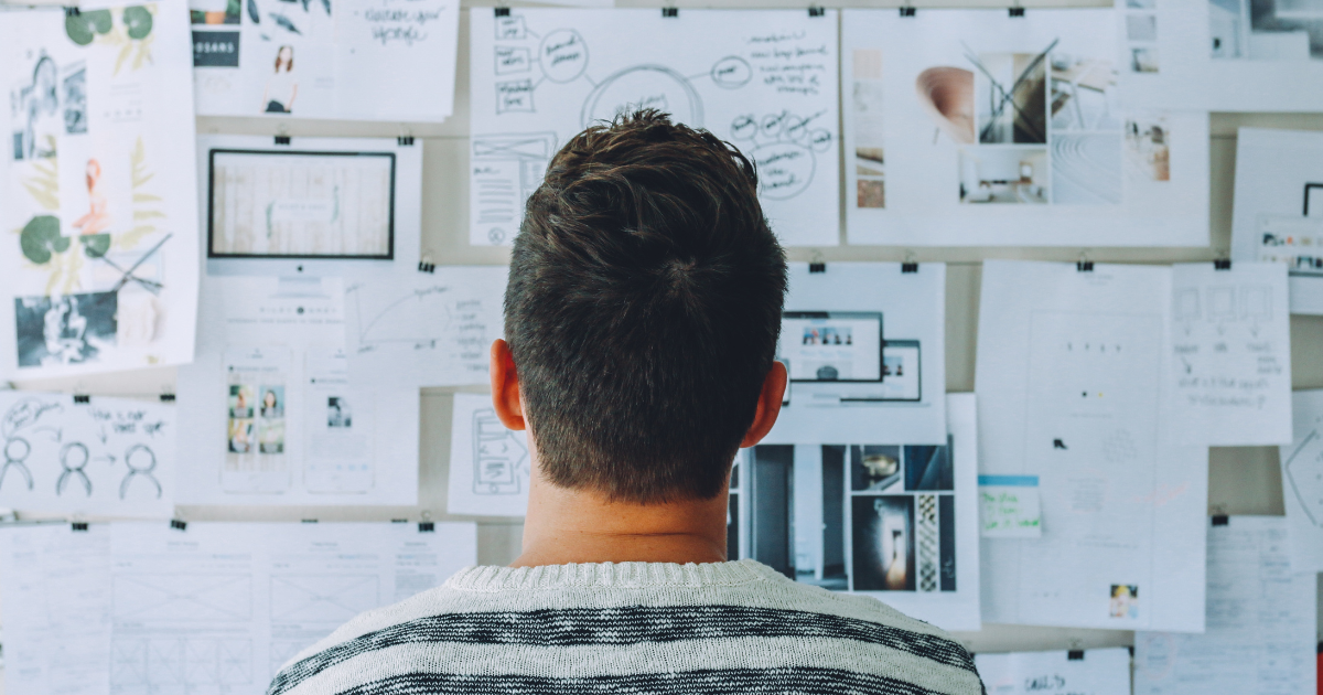 Image of back of person's head as they look at a vision wall to represent a start-up employee and how an 83(b) election could be right for them.